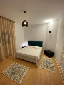 a bedroom with a bed and two rugs at Cosy Flat Lac 1, Tunis in Tunis