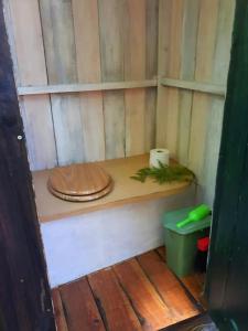a toilet sitting on a wooden shelf in a room at L'hermitage d'Apollon au sein d'un jardin forêt près de l'océan in Mimizan