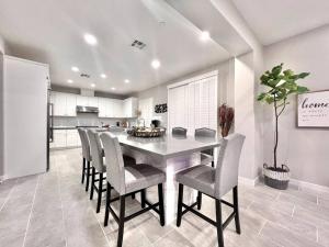 a kitchen with a dining room table and chairs at San Diego Luxury Oasis in Spring Valley