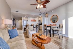 a living room with a couch and a table at Sterling Reef in Panama City Beach
