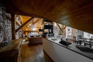 a kitchen and living room with a stone wall at Vintage Industrial City Apartments in Košice