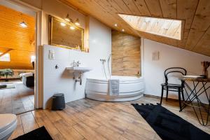 a large bathroom with a tub and a sink and a sink at Vintage Industrial City Apartments in Košice