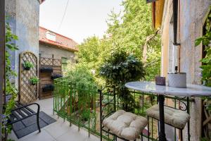 a patio with a table and chairs on a balcony at Vintage Industrial City Apartments in Košice