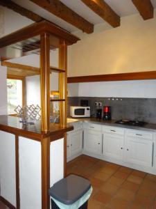 a kitchen with white cabinets and a counter top at Gîte Clé des Champs in Saint-Laurent-en-Royans