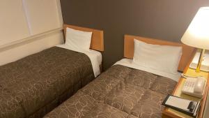Postel nebo postele na pokoji v ubytování Az Inn Fukui (Ace Inn Fukui) + 15 fotografií