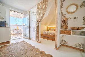 a large mirror in a room with a bedroom at Design Sea Apartment -BOHO SUITE- Abruzzo in Francavilla al Mare