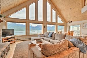 a living room with a couch and a tv and windows at Breathtaking Lake-View Retreat with On-Site Hiking! in Twin Lakes
