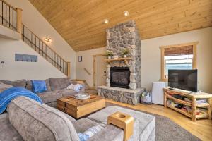 a living room with a couch and a fireplace at Breathtaking Lake-View Retreat with On-Site Hiking! in Twin Lakes
