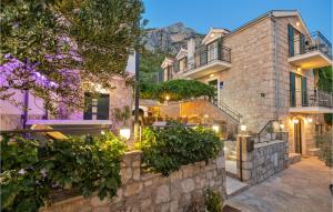 a large stone house with a stone wall at Nice Home In Makarska With Heated Swimming Pool in Makar