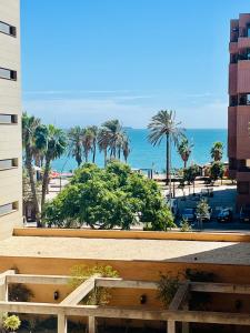 a view of the beach and the ocean from a building at Luxury Pacifico Beach in Málaga