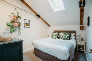 a bedroom with a bed in a room with a window at The Clock Tower Stow in Stow on the Wold