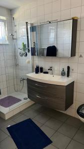 a bathroom with a sink and a shower at Apartment centrally located in the Rhine-Main area in Riedstadt