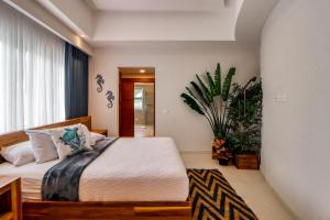 a bedroom with a bed and a potted plant at Hermosa Wave C2 in Playa Hermosa +32 photos