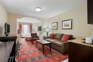 a hotel room with a couch and a living room at Best Western Plus Red Deer Inn & Suite in Red Deer