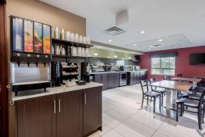 a large kitchen with a bar and a dining room at Best Western Plus Red Deer Inn & Suite in Red Deer