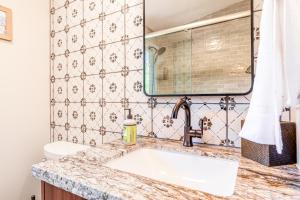 a bathroom with a sink and a toilet at The Shack in Kailua-Kona +30 photos