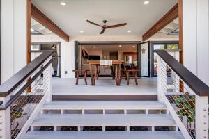 a dining room and kitchen with a table on a deck at The Shack in Kailua-Kona