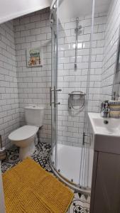 a bathroom with a shower and a toilet and a sink at The Aintree - By CHAPS in Aintree