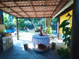a patio with a table and a playground at Casa temporada na praia Joia do Atlântico - Ilhéus - Ba in Ilhéus