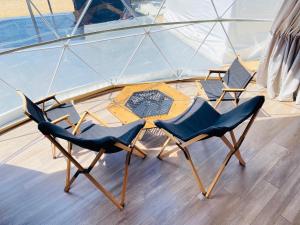 two chairs and a table on a boat at 8point resort Awaji in Awaji