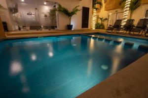 een zwembad met blauw water in een huis bij Hotel Villas Segovia Suites Playa del Carmen in Playa del Carmen