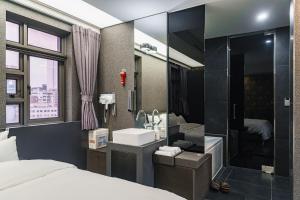 a bathroom with a bed and a sink and a shower at Starhills Hotel in Seoul