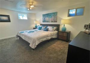 a bedroom with a bed and a table with a lamp at Modern 7-bedroom Home Near Downtown SLC in Millcreek