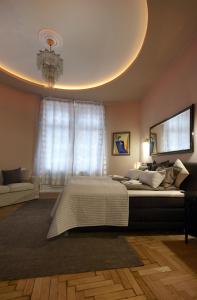 a bedroom with a large bed and a chandelier at Urban Flats Vienna City Center in Vienna