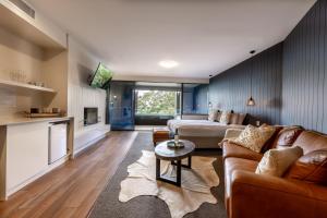 a living room with a couch and a bed at Luxury Spa Retreat with Ocean and Hinterland Views in Montville