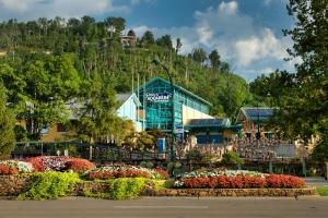 a building with a bunch of flowers in front of it at Beary Patch Hill Hot Tub 9 Miles to Great Smoky Mtn National Park in Sevierville