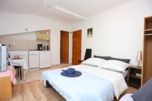 - une chambre avec un lit doté d'un chapeau bleu dans l'établissement Studio Podstrana 17053b, à Podstrana