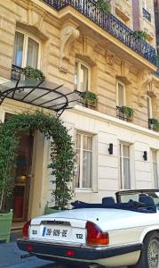 a white car parked in front of a building at Beausejour Ranelagh in Paris