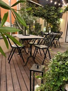 an outdoor patio with tables and chairs and plants at Beausejour Ranelagh in Paris