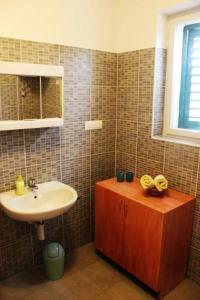 a bathroom with a sink and a mirror and a sink at Apartments with a parking space Murter - 17059 in Murter +17 photos