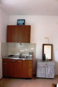 a kitchen with a sink and a mirror at Apartments with a parking space Murter - 17059 in Murter