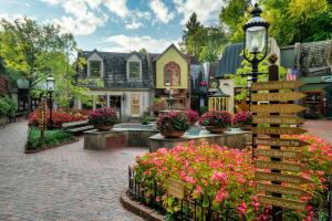 a street with flowers in front of a house at Fireflies and Moonshine in Gatlinburg