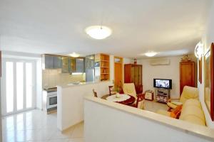 a kitchen and living room with a couch and a table at Apartments by the sea Sumartin, Brac - 17090 in Sumartin