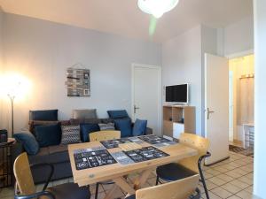 a living room with a table and a couch at Appartement La Bourboule, 3 pièces, 6 personnes - FR-1-608-236 in La Bourboule