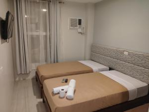 Postel nebo postele na pokoji v ubytování D' Loft Iligan