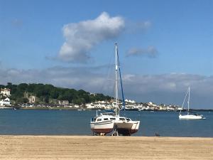 two boats parked on a beach near the water at Beach Retreat in Bideford