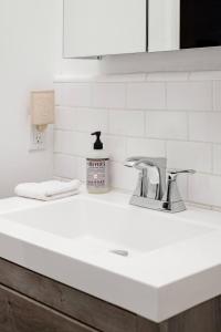 a white kitchen counter top with a sink at The Exquisite Venice Beach Bungalow with Garden in Los Angeles