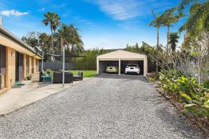 a garage with a white car in it at NAROO7- PRIME, CENTRE OF MOOLOOLABA LOCATION in Mooloolaba