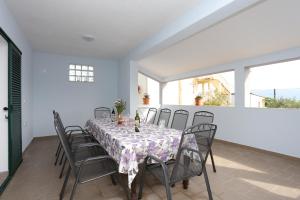 a dining room with a table and chairs at Seaside family friendly house with a swimming pool Slatine, Ciovo - 17231 in Slatine