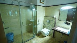 a bathroom with a shower and a toilet and a sink at Anuraag Villa in Jaipur