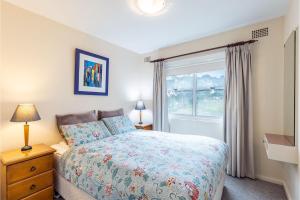 a bedroom with a bed and a window at Sunnie Belle, 2,3 Victoria Parade - Unit with water views and air conditioning in Nelson Bay