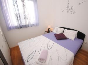 a bedroom with a bed with a drawn on it at Apartments with a parking space Rogoznica - 17106 in Rogoznica