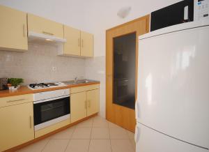 a kitchen with white appliances and a white refrigerator at Apartments with a parking space Rogoznica - 17106 in Rogoznica