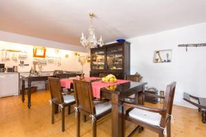 a kitchen and dining room with a table and chairs at Family friendly house with a swimming pool Bajcici, Krk - 17293 in Malinska