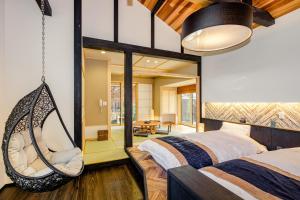 um quarto com uma cama suspensa e um baloiço em Hamabe no Yado Asahiya em Himi