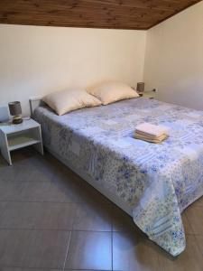 a bedroom with a bed with a blue comforter at Apartments with WiFi Susak, Losinj - 17303 in Susak